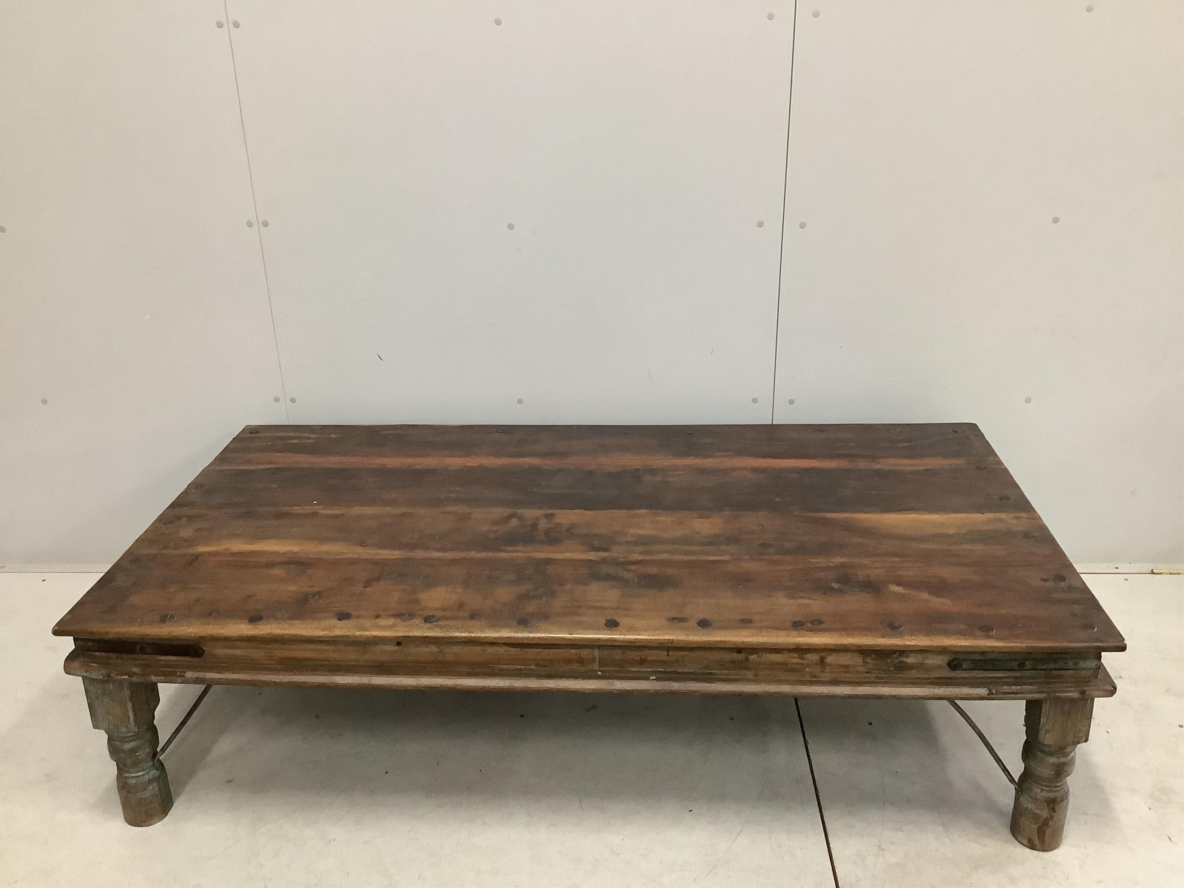 An Indian rectangular iron studded low hardwood coffee table, width 174cm, depth 90cm, height 46cm. Condition - fair